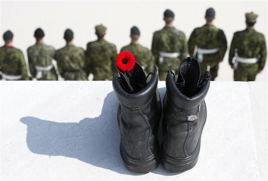 A black boot with a red poppy/(AP Photo/Virginia Mayo)