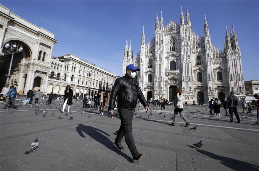 Άνδρας περπατά έξω από το Duomo του Μιλάνου (AP Photo/Luca Bruno)