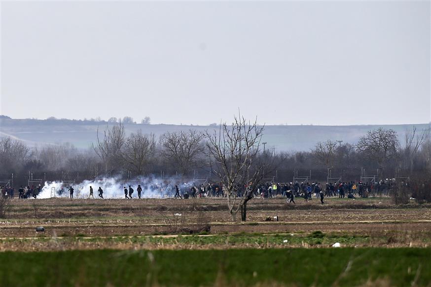 Πρόσφυγες και μετανάστες πετούν δακρυγόνα στις ελληνικές δυνάμεις  (AP Photo/Emrah Gurel)