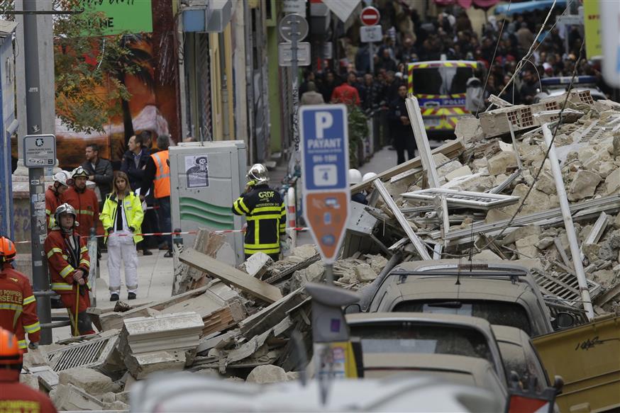 Firefighters work at the scene where a building collapsed In Marseille, southern France (AP Photo/Claude Paris)