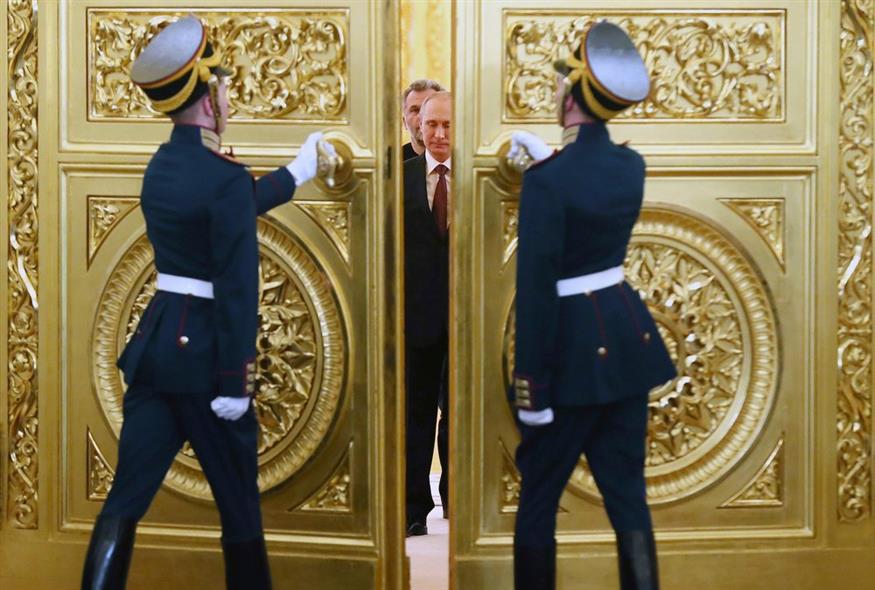 Φρουροί ανοίγουν τις πόρτες για τον Ρώσο πρόεδρο Βλαντίμιρ Πούτιν και ακολουθούν οι ηγέτες της Κριμαίας που εισέρχονται στην αίθουσα / AP Photo/Sergei Ilnitsky / Φωτογραφία αρχείου
