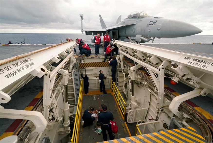 Το προσωπικό του τμήματος οπλισμού εργάζεται σε έναν ανελκυστήρα οπλισμού στο κατάστρωμα πτήσεων του αεροπλανοφόρου USS Gerald R. Ford (AP)