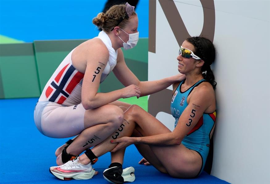 Η Κλερ Μισέλ, δεξιά, δέχεται τη βοήθεια της Νορβηγίδας Λότε Μίλερ στους Ολυμπιακούς Αγώνες στο Τόκιο. /copyright Ap Photos